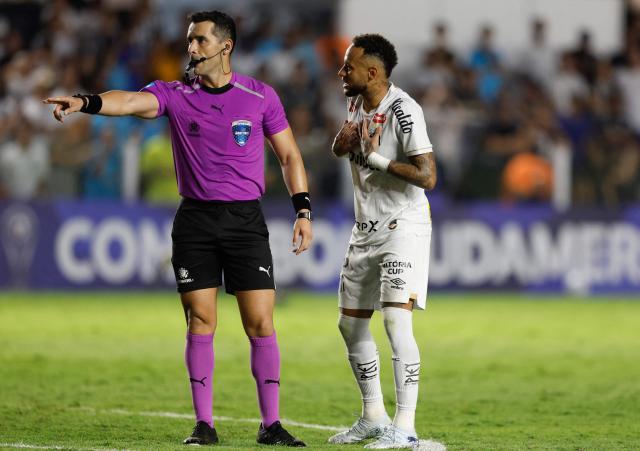 Chilean referee Fernando Vejar gestures as Santos' forward #10 Neymar complains during the Copa Sudamericana group stage football match between Brazil's Santos and Paraguay's Deportivo Recoleta at Urbano Caldeira stadium in Santos, state of Sao Paulo, Brazil on April 14, 2026. (Photo by Miguel SCHINCARIOL / AFP)