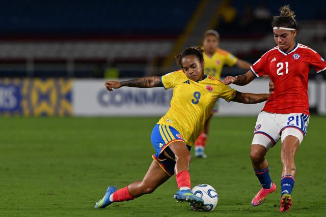 Colombia's forward #09 Gisela Robledo and Chile's forward #21 Lesly Olivares fight for the ball during the CONMEBOL Nations League Women football match between Colombia and Chile, at the Olimpico Pascual Guerrero stadium in Cali, Valle del Cauca, Colombia, on April 14, 2026. (Photo by JOAQUIN SARMIENTO / AFP)