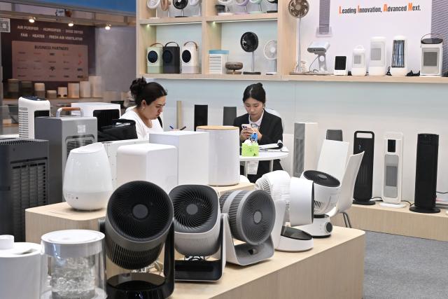 Vendors are seen at their booth at the Hong Kong Electronics Fair 2026 at the Convention and Exhibition Centre in Hong Kong on April 15, 2026. (Photo by Peter PARKS / AFP)