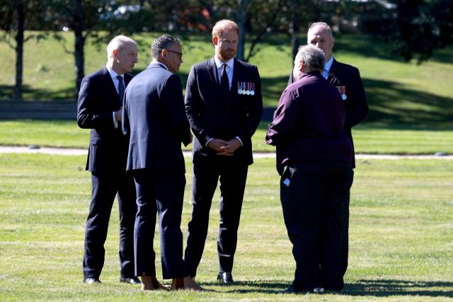 Britain's Prince Harry, the Duke of Sussex (C), speaks to dignitaries during a visit to the Australian War Memorial  in Canberra on April 15, 2026. (Photo by DAVID GRAY / AFP)