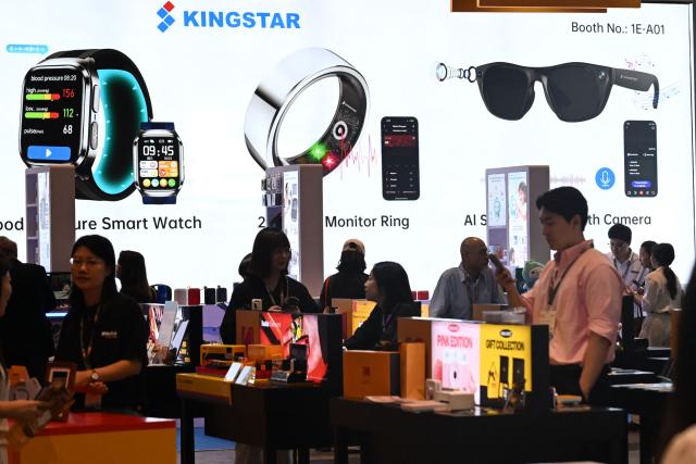 Visitors look at products at the Hong Kong Electronics Fair 2026 at the Convention and Exhibition Centre in Hong Kong on April 15, 2026. (Photo by Peter PARKS / AFP)