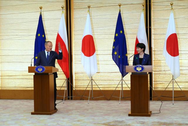 Poland's Prime Minister Donald Tusk (L) speaks during a news conference with Japan's Prime Minister Sanae Takaichi at the prime minister's office in Tokyo on April 15, 2026. (Photo by Hiro Komae / POOL / AFP)