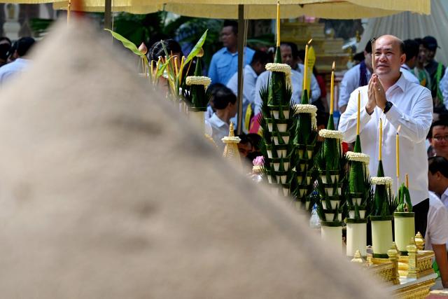 Cambodia's Deputy Prime Minister Hun Many prays in front of a sand stupa during celebrations for the Khmer New Year, known as Nokor Sankranta, in Phnom Penh on April 15, 2026. (Photo by TANG CHHIN Sothy / AFP)