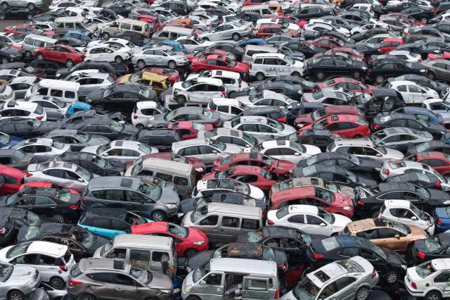 Aerial view of a large number of scrapped cars piled up in an open area on the outskirts of Hangzhou, in China's eastern Zhejiang province, on April 15, 2026. (Photo by CN-STR / AFP) / China OUT