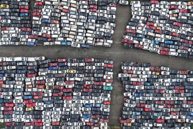 Aerial view of a large number of scrapped cars piled up in an open area on the outskirts of Hangzhou, in China's eastern Zhejiang province, on April 15, 2026. (Photo by CN-STR / AFP) / China OUT