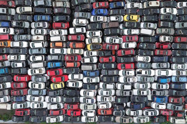 Aerial view of a large number of scrapped cars piled up in an open area on the outskirts of Hangzhou, in China's eastern Zhejiang province, on April 15, 2026. (Photo by CN-STR / AFP) / China OUT