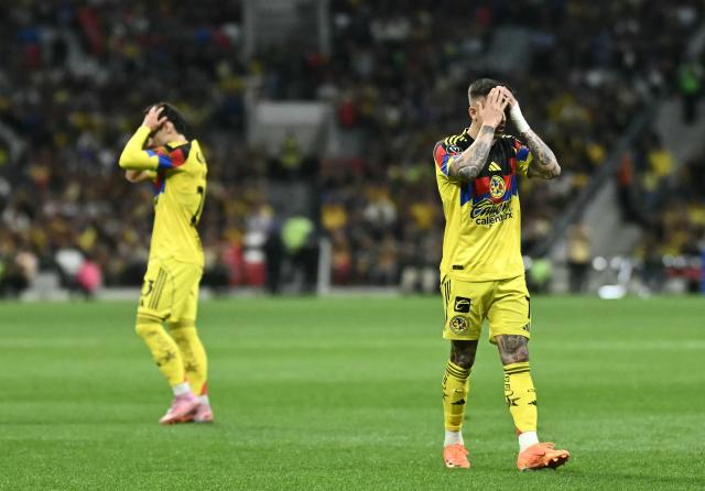 America's Brazilian midfielder #23 Raphael Veiga (L) and Uruguayan midfielder #07 Brian Rodriguez react during the CONCACAF Champions Cup quarterfinal football match between Mexico's America and US' NashvilleSC, at Banorte stadium in Mexico City, on April 14, 2026. (Photo by CARL DE SOUZA / AFP)