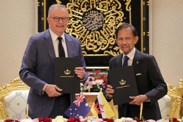 Brunei's Sultan Hassanal Bolkiah (R) and Australia's Prime Minister Anthony Albanese (L) pose with documents after a signing ceremony at Istana Nurul Iman in Bandar Seri Begawan on April 15, 2026. Albanese is travelling to Brunei and Malaysia to discuss energy and food security, his office said on April 12, continuing regional efforts to shore up fuel supplies for a nation reliant on imports. (Photo by Muhammad Rudean / AFP)