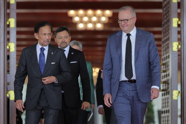 Brunei's Sultan Hassanal Bolkiah (L), Brunei's Crown Prince Al-Muhtadee Billah (C) and Australia's Prime Minister Anthony Albanese (R) walk after their official luncheon at Istana Nurul Iman in Bandar Seri Begawan on April 15, 2026. Albanese is travelling to Brunei and Malaysia to discuss energy and food security, his office said on April 12, continuing regional efforts to shore up fuel supplies for a nation reliant on imports. (Photo by Muhammad Rudean / AFP)