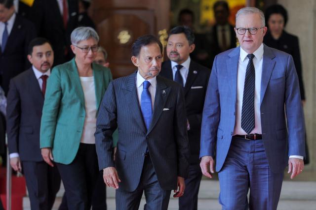 Brunei's Sultan Hassanal Bolkiah (centre L), Brunei's Crown Prince Al-Muhtadee Billah (centre R), Australia's Foreign Minister Penny Wong (2nd L) and Australia's Prime Minister Anthony Albanese (R) walk after their official luncheon at Istana Nurul Iman in Bandar Seri Begawan on April 15, 2026. Albanese is travelling to Brunei and Malaysia to discuss energy and food security, his office said on April 12, continuing regional efforts to shore up fuel supplies for a nation reliant on imports. (Photo by Muhammad Rudean / AFP)