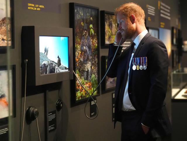 Britain's Prince Harry, the Duke of Sussex, engages with an interactive display in the Anzac Hall during a visit to the Australian War Memorial in Canberra on April 15, 2026. (Photo by Jonathan Brady / POOL / AFP)