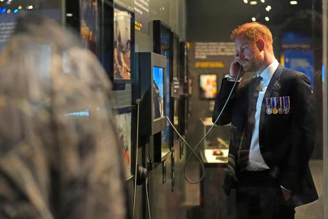 Britain's Prince Harry, the Duke of Sussex, engages with an interactive display in the Anzac Hall during a visit to the Australian War Memorial in Canberra on April 15, 2026. (Photo by Jonathan Brady / POOL / AFP)