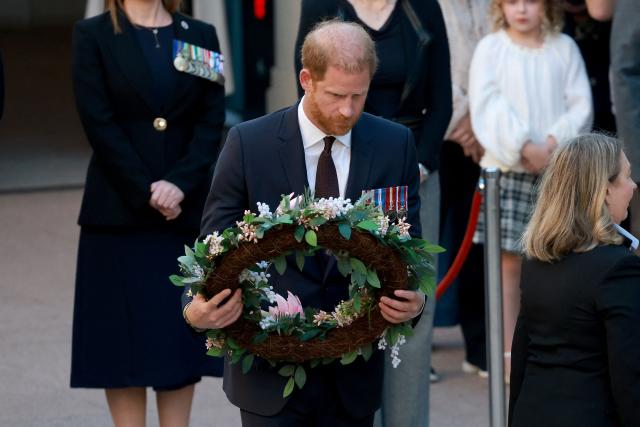Britain's Prince Harry (C), the Duke of Sussex, prepares to lay a wreath as he takes part in the Last Post ceremony during a visit to the Australian War Memorial in Canberra on April 15, 2026. (Photo by DAVID GRAY / AFP)