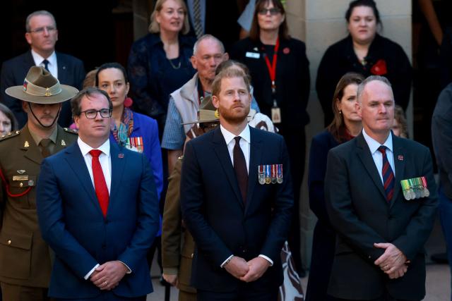 Britain's Prince Harry (C), the Duke of Sussex, stands with officials as he takes part in the Last Post ceremony during a visit to the Australian War Memorial in Canberra on April 15, 2026. (Photo by DAVID GRAY / AFP)