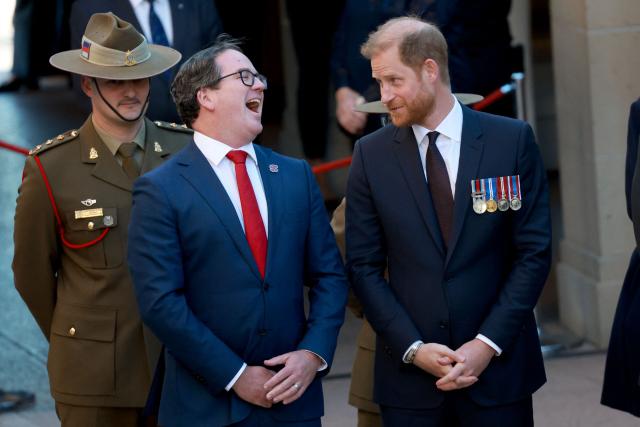 Britain's Prince Harry (R), the Duke of Sussex, talks with Australia’s Minister for Veterans' Affairs Matt Keogh (C) as they take part in the Last Post ceremony during a visit to the Australian War Memorial in Canberra on April 15, 2026. (Photo by DAVID GRAY / AFP)