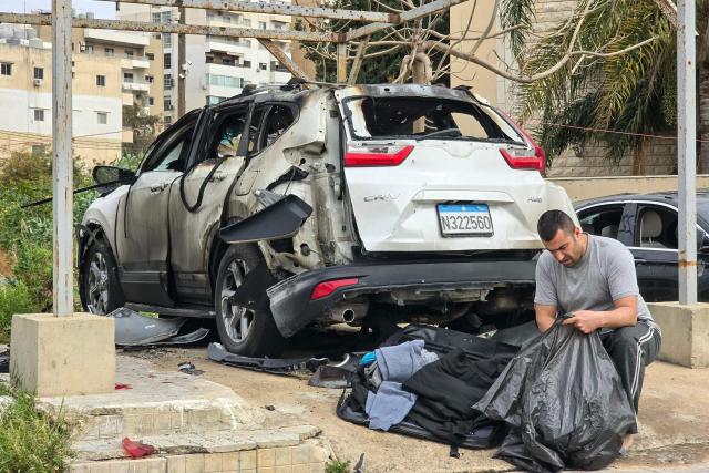 A man inspects the wreckage of a vehicle targeted overnight by an Israeli strike in the southern Lebanese coastal city of Tyre, on April 15, 2026. The US president said on April 14 that US-Iran peace talks could resume this week, while Israel and Lebanon agreed to launch direct negotiations, signaling movement on two key fronts in efforts to ease the Middle East conflict. (Photo by Kawnat HAJU / AFP)