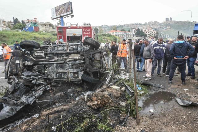 First responders and security forces work at the site of an Israeli airstrike that targeted a vehicle the Lebanese town of Jiyyeh, south of Beirut, on April 15, 2026. Two Israeli strikes on April 15 hit vehicles south of Beirut, state media reported, while Hezbollah launched rockets at Israel, hours after Lebanon and Israel agreed to hold direct negotiations. (Photo by MAHMOUD ZAYYAT / AFP)