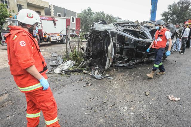 First responders and security forces work at the site of an Israeli airstrike that targeted a vehicle the Lebanese town of Jiyeh, south of Beirut, on April 15, 2026. Two Israeli strikes on April 15 hit vehicles south of Beirut, state media reported, while Hezbollah launched rockets at Israel, hours after Lebanon and Israel agreed to hold direct negotiations. (Photo by MAHMOUD ZAYYAT / AFP)