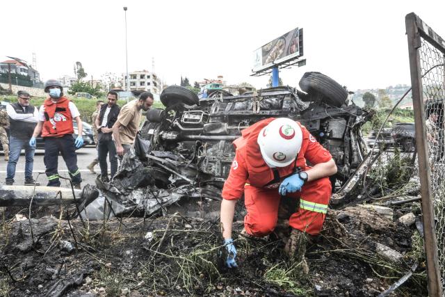 First responders inspect the site of an Israeli airstrike that targeted a vehicle the Lebanese town of Jiyeh, south of Beirut, on April 15, 2026. Two Israeli strikes on April 15 hit vehicles south of Beirut, state media reported, while Hezbollah launched rockets at Israel, hours after Lebanon and Israel agreed to hold direct negotiations. (Photo by MAHMOUD ZAYYAT / AFP)