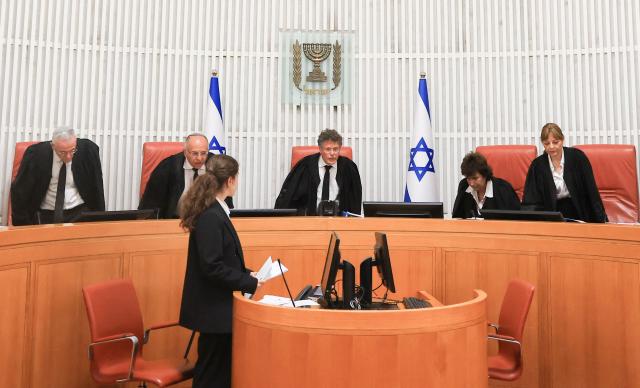 Israeli Supreme Court judges assemble to hear four petitions calling for the removal of Israel's hardline National Security Minister Itamar Ben Gvir, alleging that he has undermined the independence of the police, at the Supreme Court in Jerusalem on April 15, 2026. (Photo by Ronen Zvulun / POOL / AFP)
