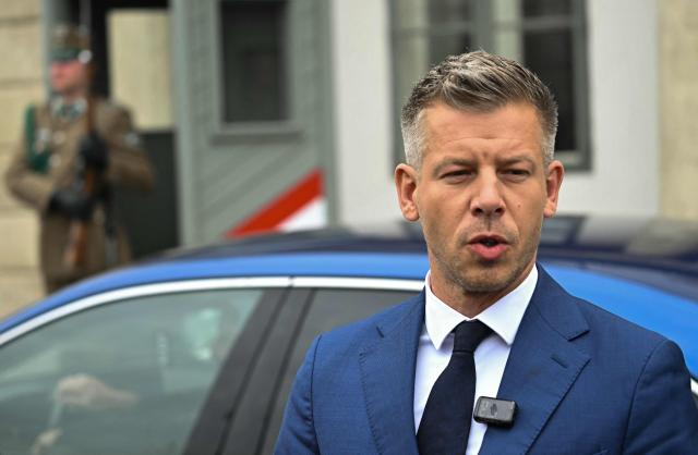 Hungary's Prime minister-elect Peter Magyar speaks as he arrives at the entrance of the Presidential Sandor Palace in Budapest on April 15, 2026 before meeting with Hungary's President and other parliamentary parties, two three days after general elections in Hungary. (Photo by Attila KISBENEDEK / AFP)