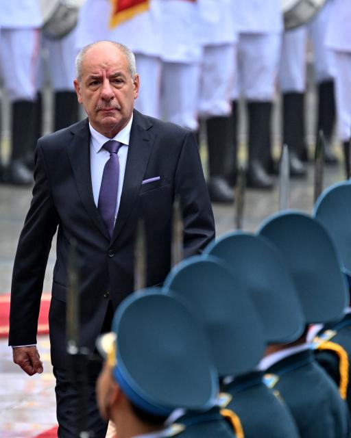 (FILES) Hungary's President Tamas Sulyok (L) reviews a guard of honour during a welcoming ceremony at the Presidential Palace in Hanoi on May 28, 2025. Hungary's new leader Peter Magyar said on April 15, 2026 that he had told President Tamas Sulyok, a supporter of ousted prime minister Viktor Orban, that he should resign following Orban's election defeat. (Photo by Nhac NGUYEN / AFP)