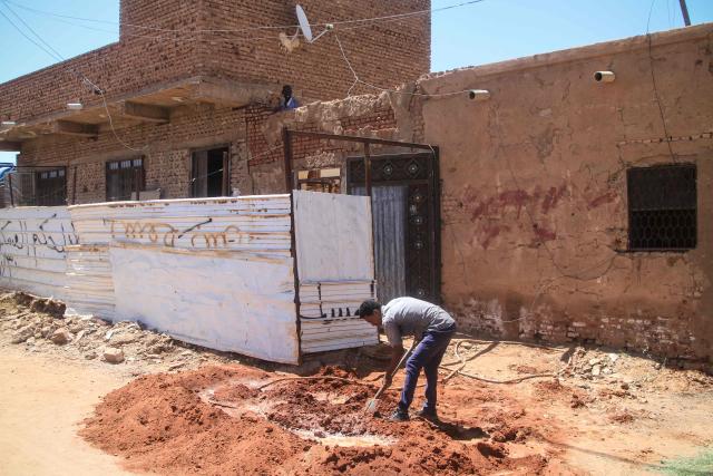 A worker prepares masonry mortar on a street in the capital Khartoum on April 15, 2026, on the third anniversary of the start of the war between the army and its paramilitary foes. On the third anniversary of the start of the grinding conflict on April 15, donors will gather in Berlin for an international conference aimed at reviving faltering peace talks and mobilising aid for one of the world's worst humanitarian crises. (Photo by Ebrahim Hamid / AFP)