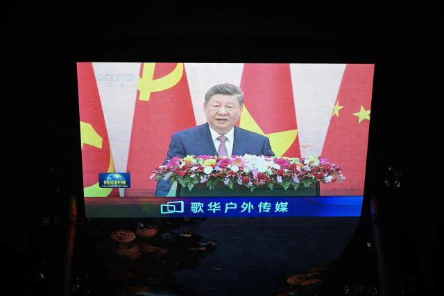 News footage on a giant screen outside a shopping mall in Beijing shows China's President Xi Jinping speaking during an event with General Secretary of the Communist Party of Vietnam and Vietnam's President To Lam on April 15, 2026. (Photo by Pedro PARDO / AFP)