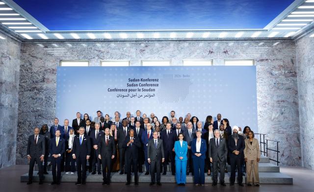 Attendants pose for a family photo during the third international conference on Sudan hosted by German Foreign Minister Johann Wadephul (6th R), at the Foreign Office in Berlin on April 15, 2026. Now entering its fourth year, the war in Sudan between the army and the paramilitary Rapid Support Forces (RSF) has killed tens of thousands of people, displaced more than 11 million, and thrust several areas into hunger and famine. Donors are due to gather in Berlin on April 15 for an international conference on the conflict, aimed at reviving faltering peace talks and mobilising aid. The meeting brings together governments, aid agencies and civil society groups, but excludes both the Sudanese army and the paramilitary Rapid Support Forces. (Photo by Odd ANDERSEN / AFP)