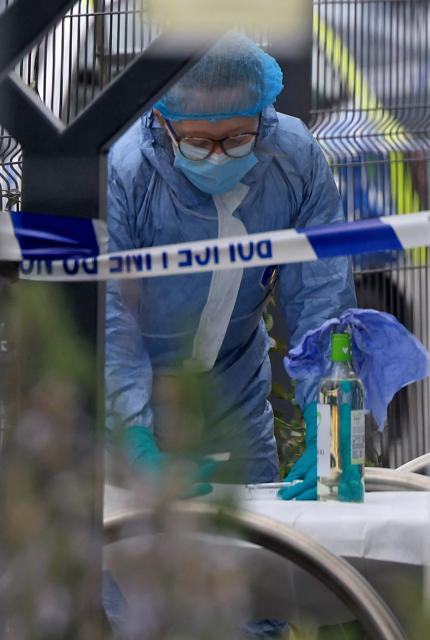 A police forensics officer works during an investigation into an attack in the early hours of the morning, at the Finchley Reform Synagogue, in the North Finchley area of north London, on April 15, 2026. Britain's Metropolitan Police said on April 15 they are seeking two suspects following an attempted arson attack at Finchley Reform Synagogue in north London, where bottles thought to have  contained petrol were thrown at the building. (Photo by Toby Shepheard / AFP)