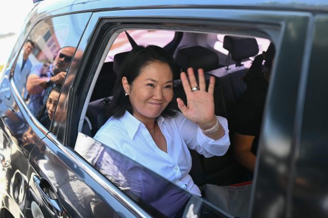 Peru’s presidential candidate for the Fuerza Popular party, Keiko Fujimori, waves as she leaves her house in Lima on April 15, 2026. Left-wing candidate Roberto Sanchez climbed to second place in Peru's presidential election on April 15, 2026, positioning himself to face conservative Keiko Fujimori in a June runoff, while his nearest challenger threatened protests over alleged voter fraud. (Photo by ERNESTO BENAVIDES / AFP)