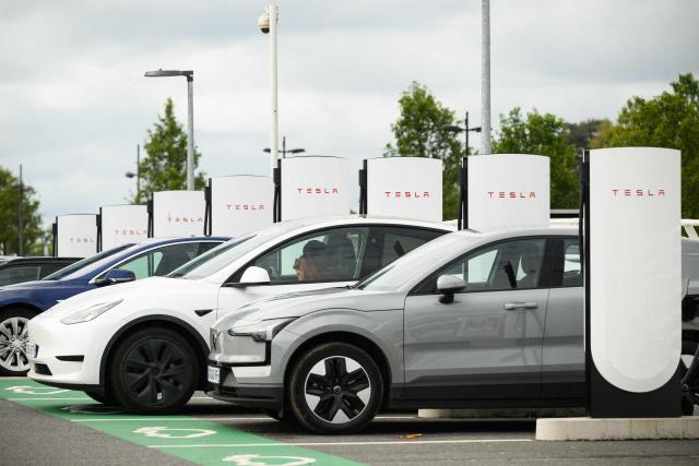 People charge their electric cars at a Tesla electric charging station in Saint-Herblain, western France, on April 15, 2026, as US-Israel war on Iran, launched on February 28, has roiled global energy and equities markets, sending oil prices skyrocketing after Tehran virtually closed the key Strait of Hormuz. (Photo by Loic VENANCE / AFP)