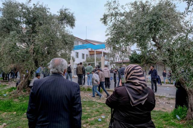 Families wait near a school where a 13 year-old teenager opened fire in Kahramanmaras, on April 15, 2026. A 13-year-old opened fire at a Turkish school on April 15, 2026, killing nine people and wounding 13, with students jumping from windows to escape the second school shooting in the country in as many days, officials said. (Photo by Orhan ERKILIC / AFP)