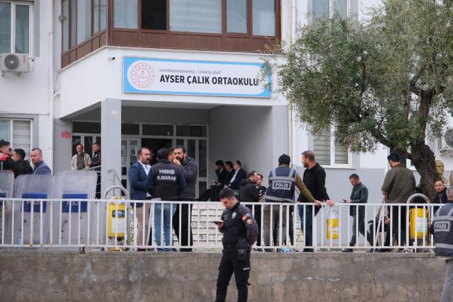 Families wait as Turkish police surround the school where a 13 year-old teenager opened fire in Kahramanmaras, on April 15, 2026. A 13-year-old opened fire at a Turkish school on April 15, 2026, killing nine people and wounding 13, with students jumping from windows to escape the second school shooting in the country in as many days, officials said. (Photo by Orhan ERKILIC / AFP)