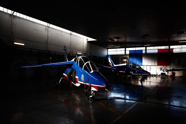 An Alphajet aircraft from France's Air Force elite aerobatic flying team "Patrouille de France" (PAF) is parked in a hangar ahead of a training session at 701 Air Base in Salon-de-Provence, south-eastern France on April 15, 2026. (Photo by Thibaud MORITZ / AFP)