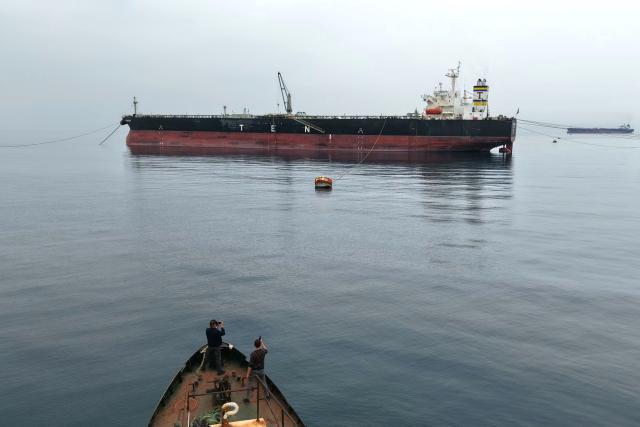 The Greek-flagged crude oil tanker "Asahi Princess" is made ready off the coast of the Syrian Baniyas port refinery, along the Mediterranean Sea on on April 15, 2026. Iraq has begun exporting crude using tanker trucks through Syria, its oil ministry said, as an official said oil revenue last month dropped more than 70 percent compared to February. More than a month into the Middle East war that has wrought havoc on energy markets, Iraq has been particularly impacted as oil exports account for some 90 percent of its budget revenues. Until Iranian attacks and threats all but shut the Strait of Hormuz in revenge for US-Israeli strikes, Iraq exported the majority of its oil through the strategic waterway. (Photo by Bakr ALkasem / AFP)