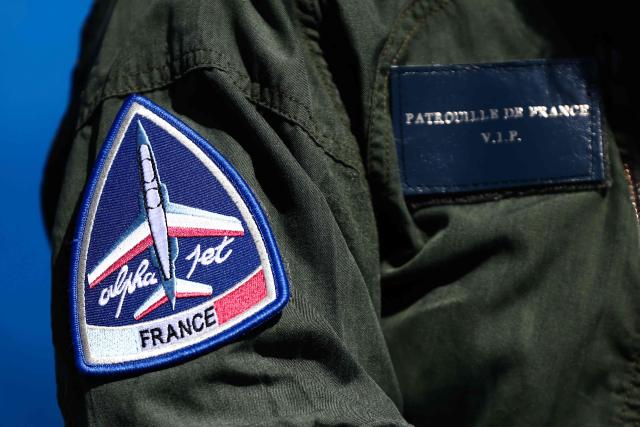 A member of France's Air Force Elite aerobatic flying team "Patrouille de France" (PAF) wears a patch featuring an Alpajet aircraft at 701 Air Base in Salon-de-Provence, south-eastern France on April 15, 2026. (Photo by Thibaud MORITZ / AFP)