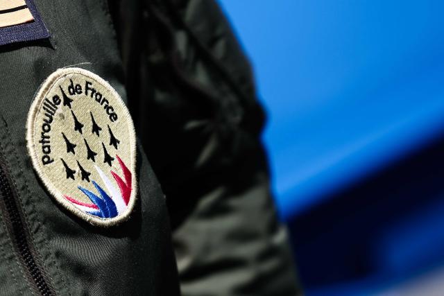 A member of France's Air Force Elite aerobatic flying team "Patrouille de France" (PAF) wears a patch bearing the PAF logo at 701 Air Base in Salon-de-Provence, south-eastern France on April 15, 2026. (Photo by Thibaud MORITZ / AFP)