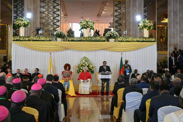 Pope Leo XIV (C) and Cameroon's First Lady Chantal Biya (CL) look on as Cameroon's President Paul Biya (CR) delivers a speech at The Presidential Palace in Yaounde, on the third day of an 11-day apostolic journey to Africa, on April 15, 2026. (Photo by Alberto PIZZOLI / AFP)