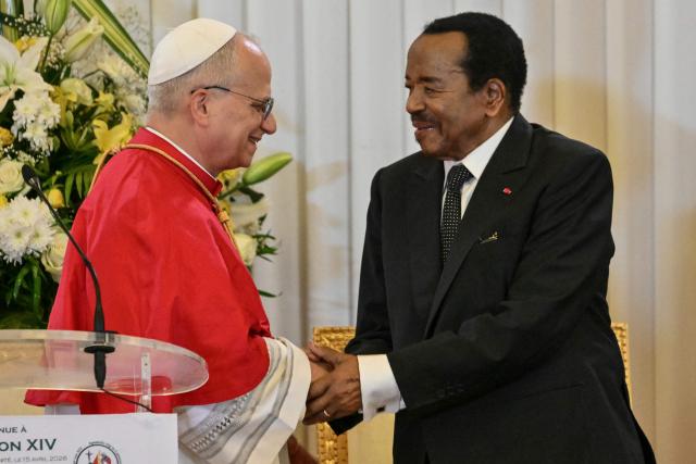 Pope Leo XIV (L) shakes hands with Cameroon's President Paul Biya (R) at The Presidential Palace in Yaounde, on the third day of an 11-day apostolic journey to Africa, on April 15, 2026. (Photo by Alberto PIZZOLI / AFP)