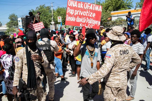 Police officers monitor the area as protestors rally against rising fuel prices in Port-au-Prince, Haiti, on April 15, 2026. Workers say that fuel prices should not exceed their minimum wage. Crude prices climbed Wednesday while stocks diverged as investors digested mixed signals about talks to end the war in the Middle East and get oil and gas flowing through the Strait of Hormuz once again. (Photo by Clarens SIFFROY / AFP)