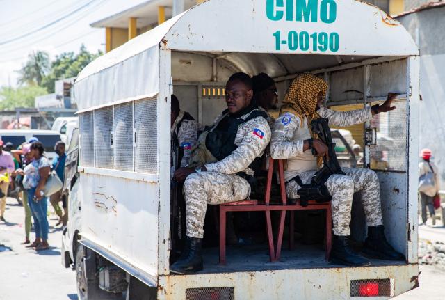 Police officers monitor the area as protestors rally against rising fuel prices in Port-au-Prince, Haiti, on April 15, 2026. Workers say that fuel prices should not exceed their minimum wage. Crude prices climbed Wednesday while stocks diverged as investors digested mixed signals about talks to end the war in the Middle East and get oil and gas flowing through the Strait of Hormuz once again. (Photo by Clarens SIFFROY / AFP)