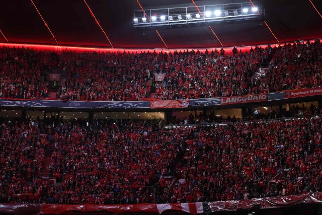 REd-white FC Bayern Munich fans are seen on the terraces prior to the start of the UEFA Champions League quarter-final second leg football match between FC Bayern Munich and Real Madrid in Munich, southern Germany, on April 15, 2026. (Photo by Karl-Josef HILDENBRAND / AFP)