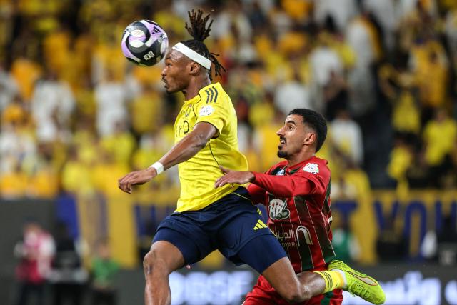 Al Nassr's #3 Mohammed Nassr's French defender #03 Mohamed Simakan heads the ball chased by Etifaq's #61 Ettifaq's Saudi defender #61 Radhi Al-Otaibi during the Saudi Pro League football match between Al-Nassr and Al-Ettifaq at the Al-Awwal Park Stadium in Riyadh on April 15, 2026. (Photo by Fayez Nureldine / AFP)