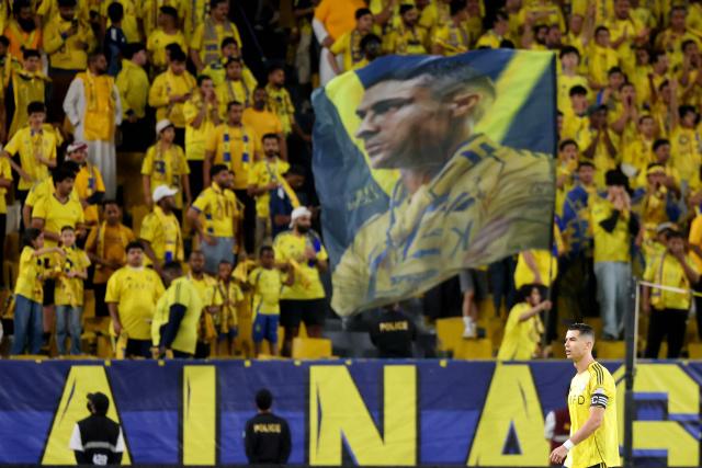 Nassr's Portuguese forward #07 Cristiano Ronaldo walks past an image of himself on a huge flag during the Saudi Pro League football match between Al-Nassr and Al-Ettifaq at the Al-Awwal Park Stadium in Riyadh on April 15, 2026. (Photo by Fayez Nureldine / AFP)