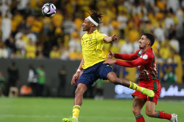 Nassr's French defender #03 Mohamed Simakan heads the ball chased by Ettifaq's Saudi defender #61 Radhi Al-Otaibi during the Saudi Pro League football match between Al-Nassr and Al-Ettifaq at the Al-Awwal Park Stadium in Riyadh on April 15, 2026. (Photo by Fayez Nureldine / AFP)