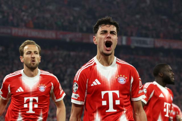 Bayern Munich's German midfielder #45 Aleksandar Pavlovic (C) celebrates with Bayern Munich's English forward #09 Harry Kane (L) after scoring the 1-1 equalizing goal during the UEFA Champions League quarter-final second leg football match between FC Bayern Munich and Real Madrid in Munich, southern Germany, on April 15, 2026. (Photo by Karl-Josef HILDENBRAND / AFP)