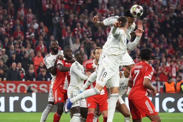 Real Madrid's Brazilian defender #03 Eder Militao (2nd R) jumps for a header during the UEFA Champions League quarter-final second leg football match between FC Bayern Munich and Real Madrid in Munich, southern Germany, on April 15, 2026. (Photo by Karl-Josef HILDENBRAND / AFP)