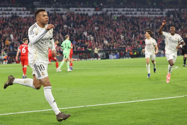 Real Madrid's French forward #10 Kylian Mbappe celebrates scoring the 2-3 goal with his teammates during the UEFA Champions League quarter-final second leg football match between FC Bayern Munich and Real Madrid in Munich, southern Germany, on April 15, 2026. (Photo by Alexandra BEIER / AFP)