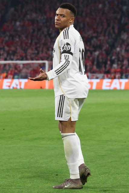Real Madrid's French forward #10 Kylian Mbappe gestures to Bayern fans who threw objects after he scored the 2-3 goal with his teammates during the UEFA Champions League quarter-final second leg football match between FC Bayern Munich and Real Madrid in Munich, southern Germany, on April 15, 2026. (Photo by Alexandra BEIER / AFP)